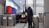 A Stena Confidential employee holding a container next to a truck.