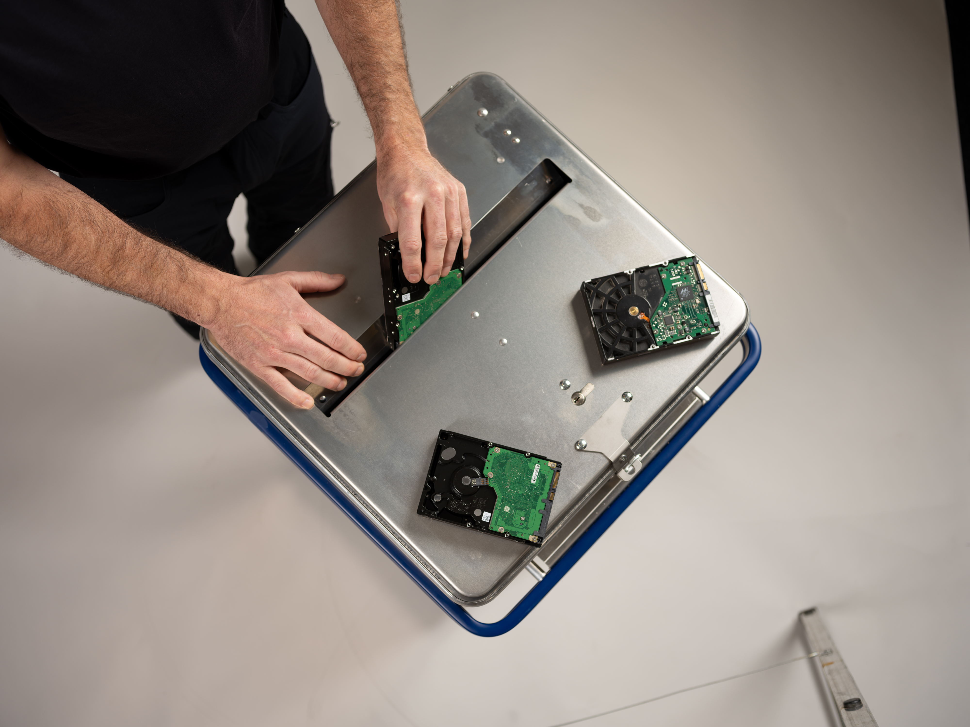 En Stena Confidential-ansatt legger elektronikkmateriale i en beholder